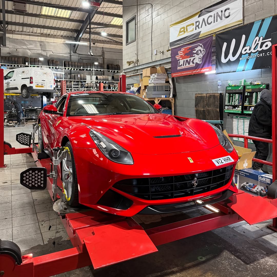 A red Ferrari on the alignment rig at White Rose Motors